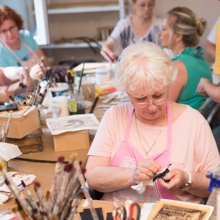  Group of women working on craft projects.